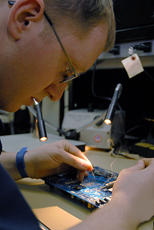 Student performing a soldering task
