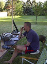 Man operating an amateur radio station in a garden