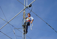 A radio amateur working at height on an antenna