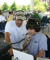 Instructor supervising student operating a radio transmitter