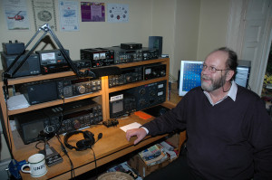 Martyn Phillips, G3RFX (SK) seen at his shack desk from where he made 1273 GB2RS broadcasts and many thousands of personal contacts