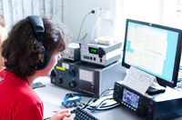 Young radio operator with headphones at YOTA 2014
