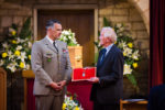 French General Poincignon (L) presents award to G2CIW's son David at his father's funeral