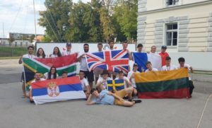 Teams of young radio amateurs holding their nation's flags