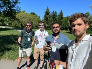 Group of young RSGB members with hand held devices for ARDF in a park