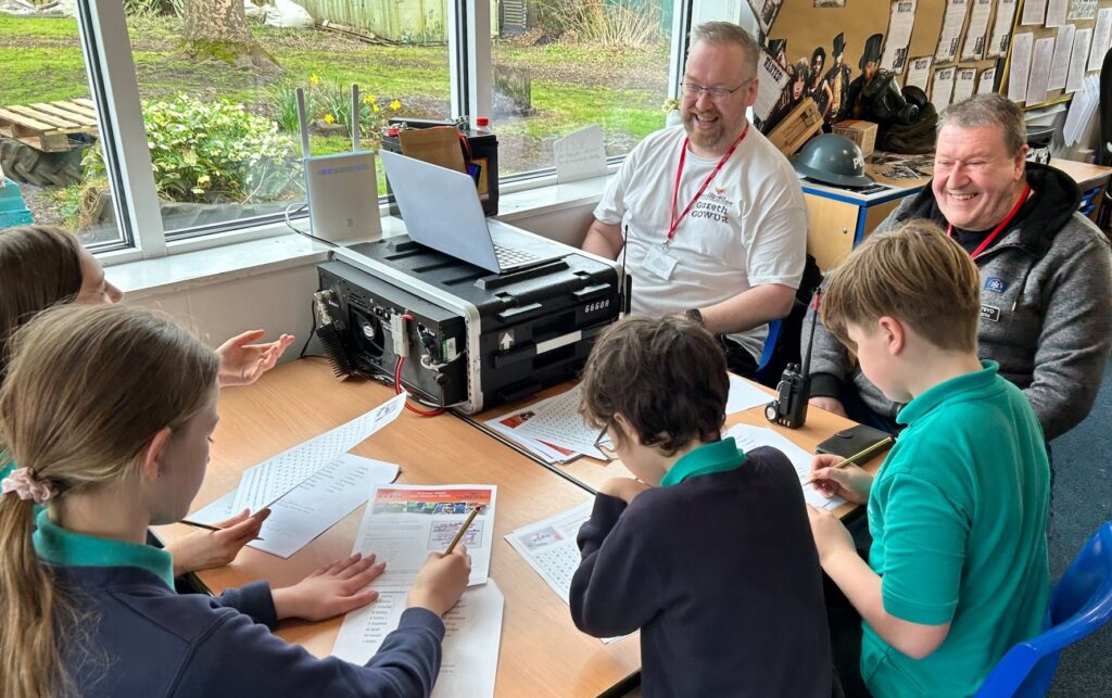 Children taking part in a radio-related task on paper sheets