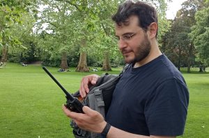 Radio amateur operating an handheld radio in a park