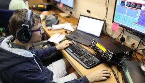 Male amateur radio operator looking a PC screen