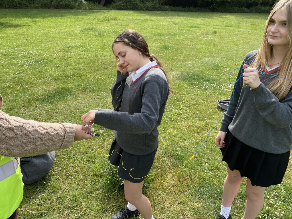 students testing crystal radio sets they made
