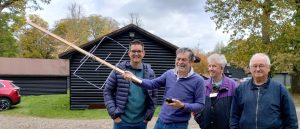 Four club members outside with one holding an antenna