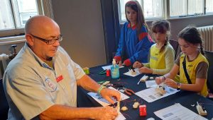 STEM Ambassador Simon Harris supporting Brownies/ Guides to make snail Morse keys